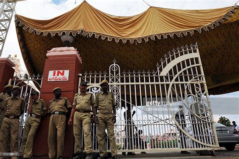 Indian Police Officials Stand Guard At The Main Gate Of The Sri Satya