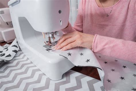 Beautiful Woman Seamstress Sew On The Sewing Machine Clothes Stock