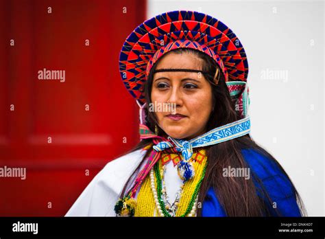 a native girl from the kamentsá tribe wearing a colorful costume takes part in the carnival in