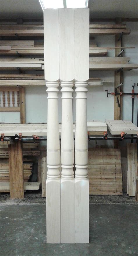 Two Tall White Pillars In A Room Filled With Wood