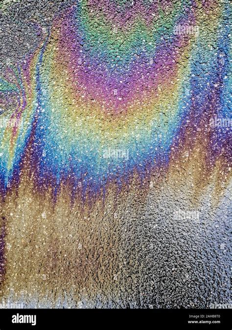 Multi Colored Oil Spill On Asphalt Road Abstract Background Stock