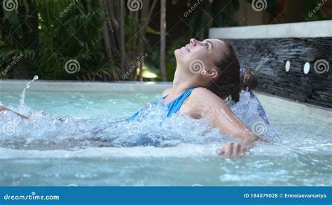 Beautiful Young Woman Relaxes In A Hydromassage Jacuzzi In Swimming