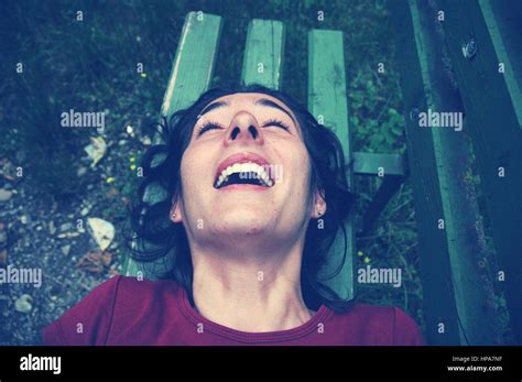 Tickling Tickled Woman Laughing On A Bench Toned Image Stock Photo