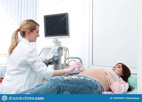 Young Pregnant Woman Undergoing Ultrasound Scan In Clinic Stock Image Image Of Doctor Female
