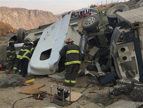 update truck driver pinned in cab of overturned semi