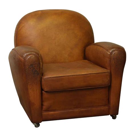 This charming club chair features a solid hardwood frame with bonded leather upholstery. Vintage Rolling Brown Leather Club Chair | Olde Good Things
