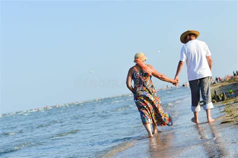 sea walk and happy mature couple at seashore sandy beach and holding hands stock image image