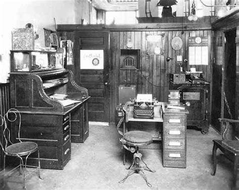 An Old Fashioned Office With Many Desks And Chairs In The Room