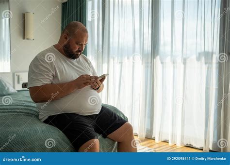 Fat Bearded Bald Guy With Smartphone Chatting Dials Number Types