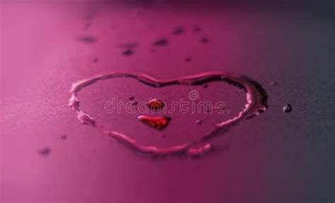Vibrant Water Drops Heart Shape On Purple Background Stock Image