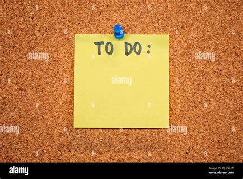 Yellow Sticky Note On A Cork Board With Drawing Pin With The Word To Do