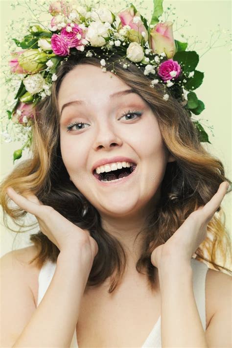 Portrait Of A Smiling Young Girl In A Wreath Of Roses Stock Photo