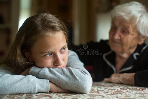 A Crying Little Girl Is Comforted By Her Grandmother Stock Image
