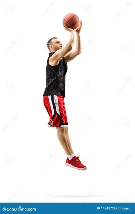 Male Basketball Player Jumping And Shooting A Ball Stock Photo Image