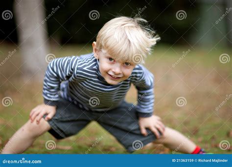Boy With Hands On Knee Stock Image Image Of Smiling 21363159