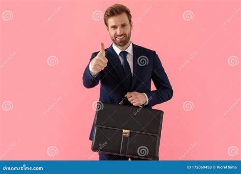 Positive Businessman Giving A Thumbs Up And Holding A Briefcase Stock