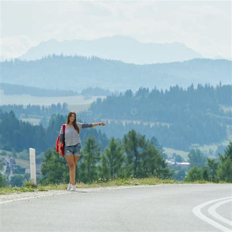 pretty girl hitchhiking along the road stock image image of panorama alone 71658605
