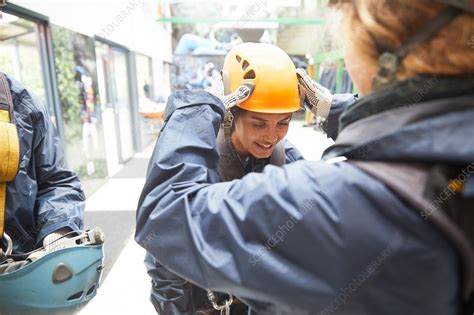 Woman Helping Friend With Zip Line Helmet Stock Image F0222876
