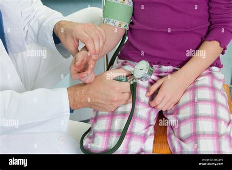 Doctor Testing Childs Blood Pressure Stock Photo Alamy