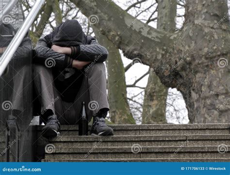 Tired Person Crying While Sitting On Top Of The Stairs Stock Image