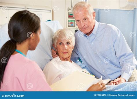 Nurse Talking To Senior Couple On Ward Stock Photo Image Of Caucasian