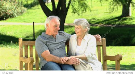 Old Man And Woman Talking On A Bench Stock Video Footage 4542186