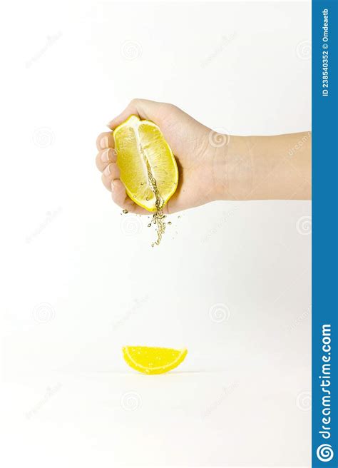 Female Hand Squeezing Half Of Lemon In Dessert Marmalade In The Form Of