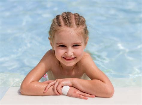 Premium Photo Smiling Girl Swim To The Poolside