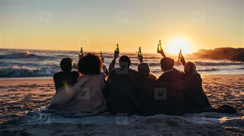 Group Of Friends Enjoying Beach Sunset With Beers Stock Photo 157642