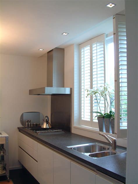 This timeless window treatment style can accommodate large window expanses and most specialty shapes. Kitchen interior window shutters - Total Window Shutters