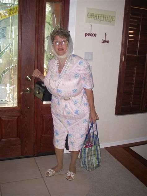 An Older Woman Is Standing In Front Of A Door With Her Handbag And Purse