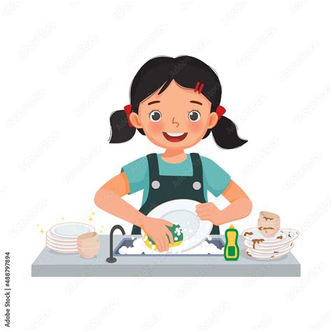 Happy Cute Little Girl Washing Dishes Standing At Sink In The Kitchen