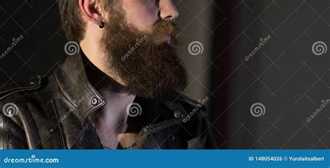 Portrait Of A Brooding Bearded Man In A Leather Jacket Stock Photo