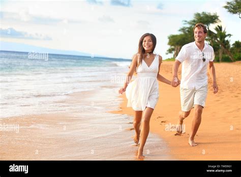 Beach Couple Walking On Romantic Travel Honeymoon Having Fun Running On