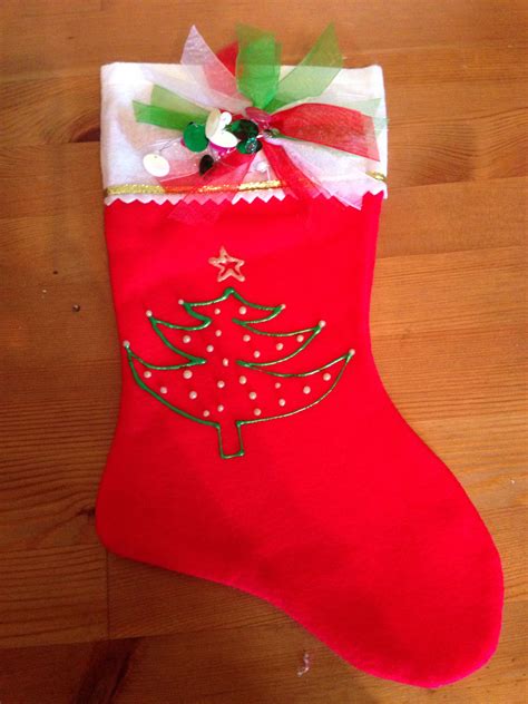 A Red Christmas Stocking With A Green And White Bow On It Sitting On A