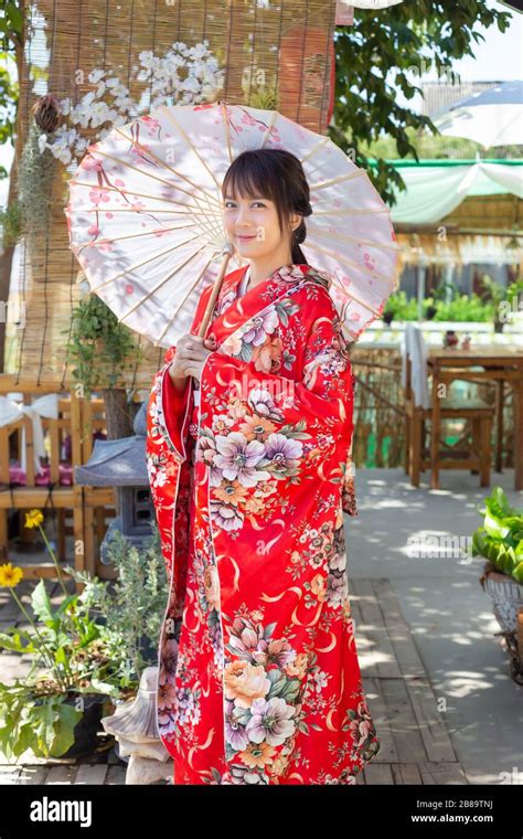 The Girl Is Wearing A Red Traditional Kimono Which Is The National