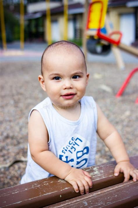 Cute Happy Smiling Baby Boy Playing With Colorful Toy Car At Children