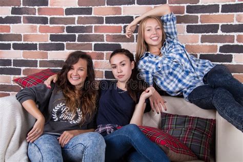 Three Girls Smiling Sitting On The Couch Stock Image Image Of