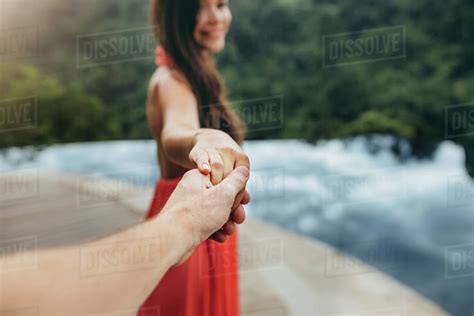 Close Up Of Woman Holding Hand Of A Man Near Poolside Focus On Hands