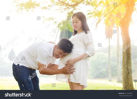 asian man listening his pregnant wifes ภาพสต็อก 411043933 shutterstock