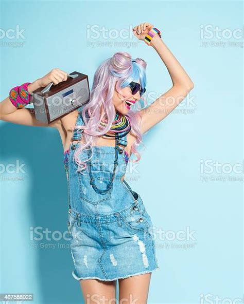 Pink Hair Girl In Funky Manga Outfit Holding Small Radio Stock Photo