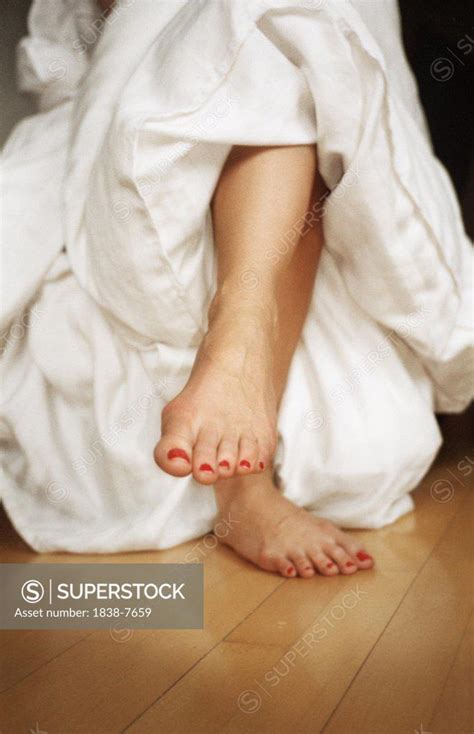 Woman Sitting With Crossed Legs And Bare Feet Superstock