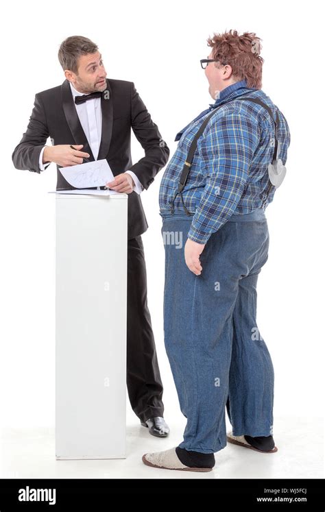Elegant Man In A Tuxedo And Bow Tie Standing Arguing With An Overweight