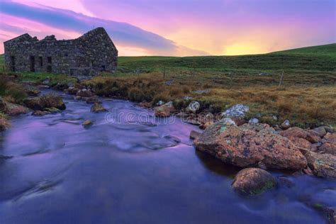 An Old Ruined Bothy On A Scottish Moor And A Creek Flows Through Stock
