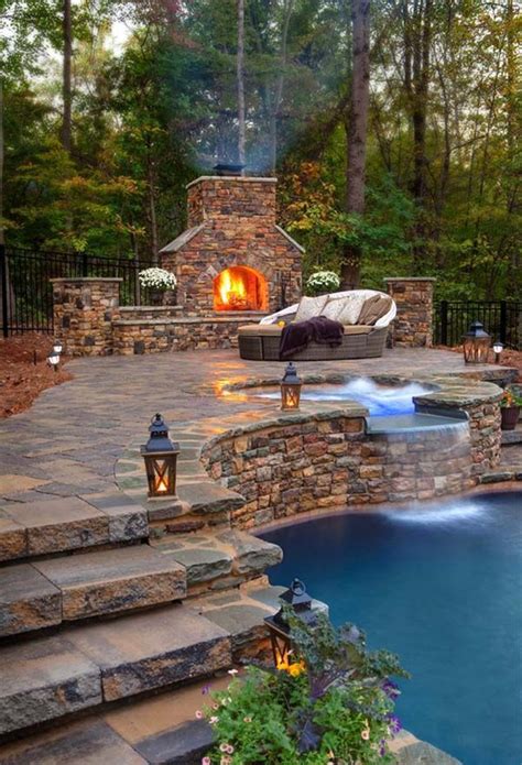 An Outdoor Fireplace Next To A Pool In The Middle Of A Wooded Area With