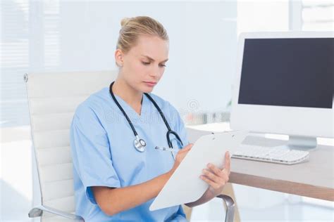 Concentrated Nurse Writing On Clipboard Stock Image Image Of Keyboard