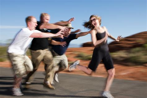 Group Of Men Chasing A Woman Stock Photo Download Image Now Istock