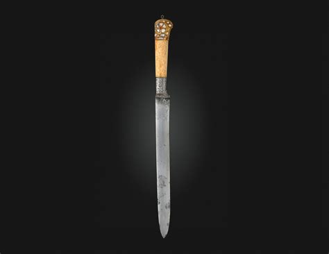 a carved and gem set walrus ivory hilted dagger