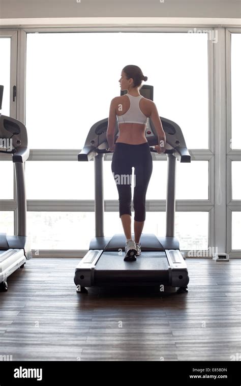 Woman Jogging On Treadmill At Gym Stock Photo Alamy