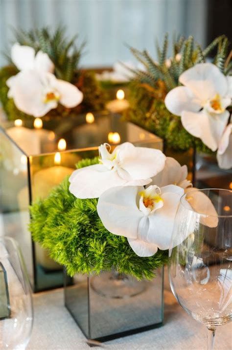 How Absolutely Chic Are These White Orchids Next To A Display Of Pillar Candles Modern Chic